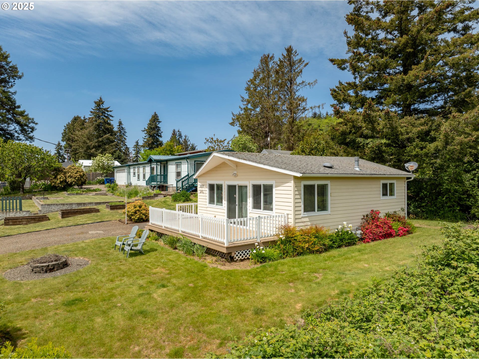 5305 Northeast 49th Street Neotsu, OR 97364 - Photo 11 of 32 a front view of house with yard and trees in the background