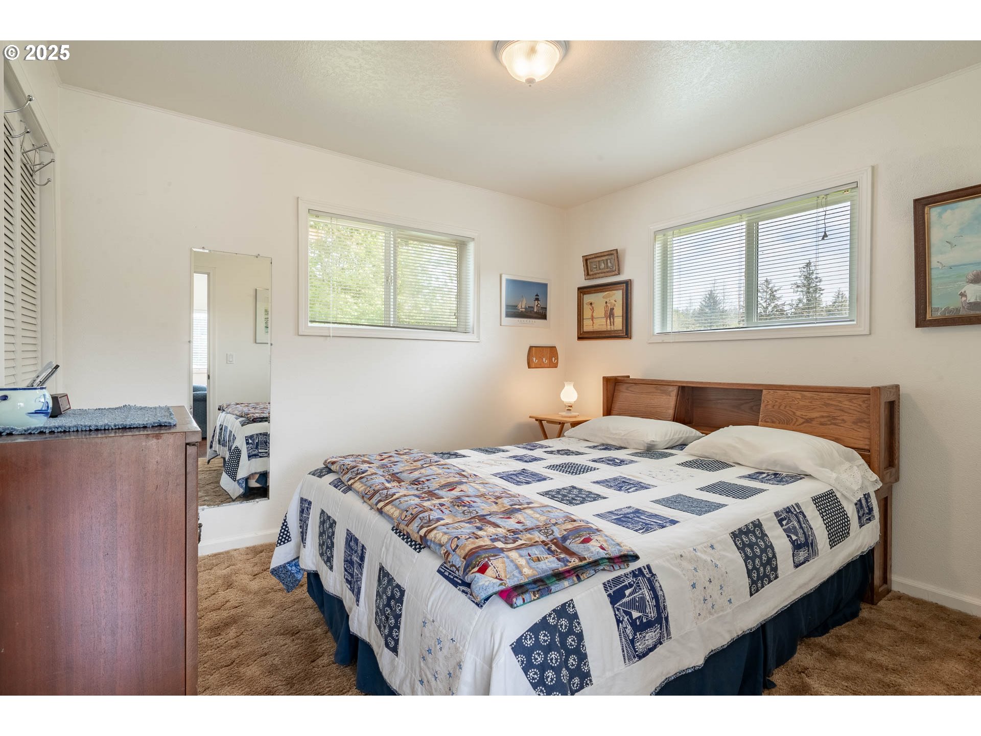 5305 Northeast 49th Street Neotsu, OR 97364 - Photo 24 of 32 a bedroom with a bed a dresser and painting