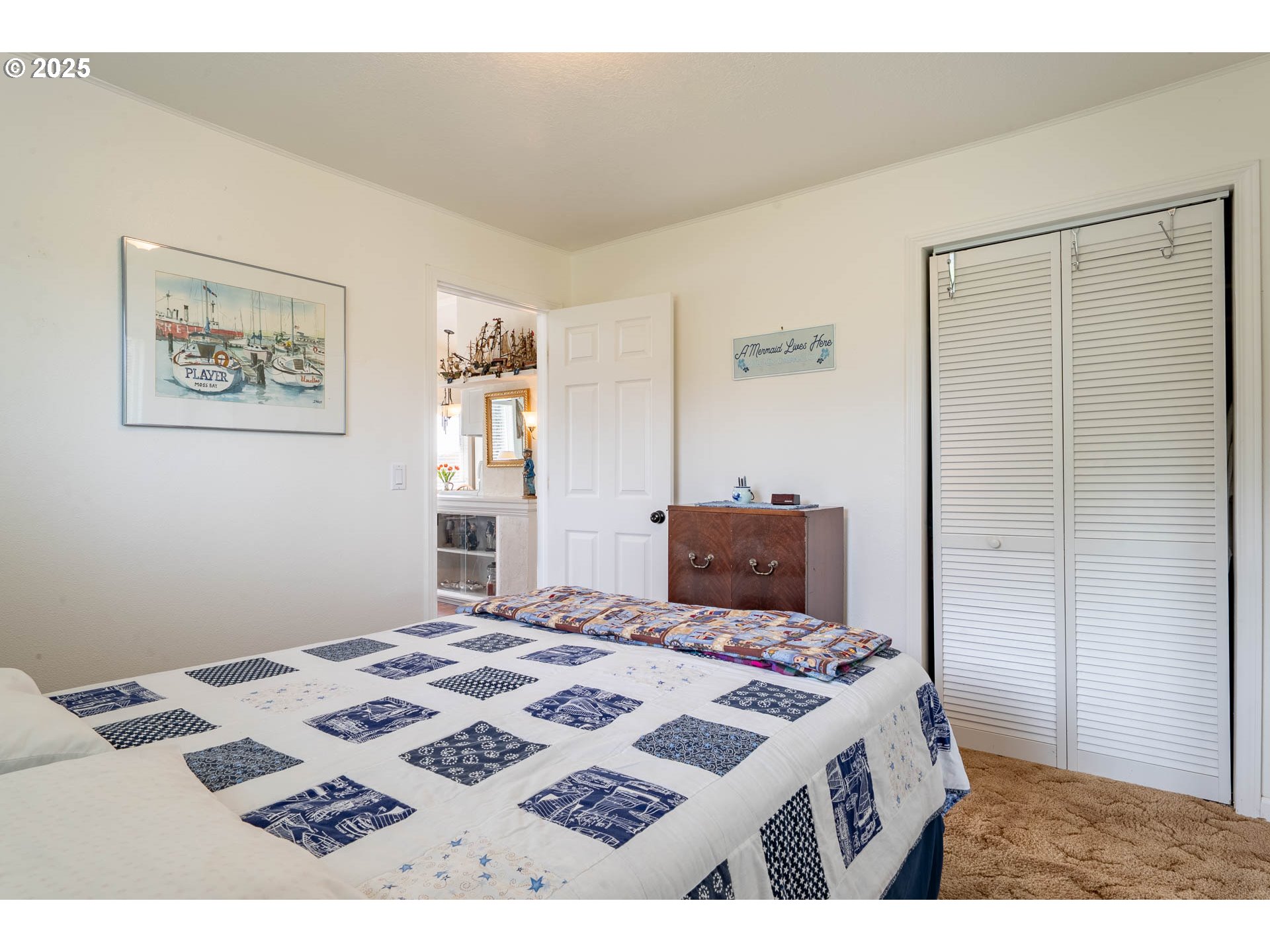 5305 Northeast 49th Street Neotsu, OR 97364 - Photo 25 of 32 a bedroom with a bed and a lamp on table