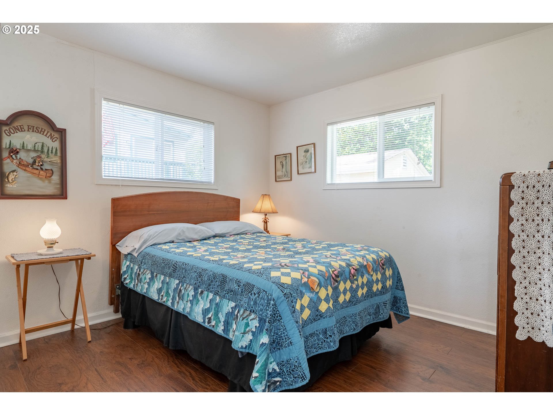 5305 Northeast 49th Street Neotsu, OR 97364 - Photo 26 of 32 a bedroom with a bed mirror and a window