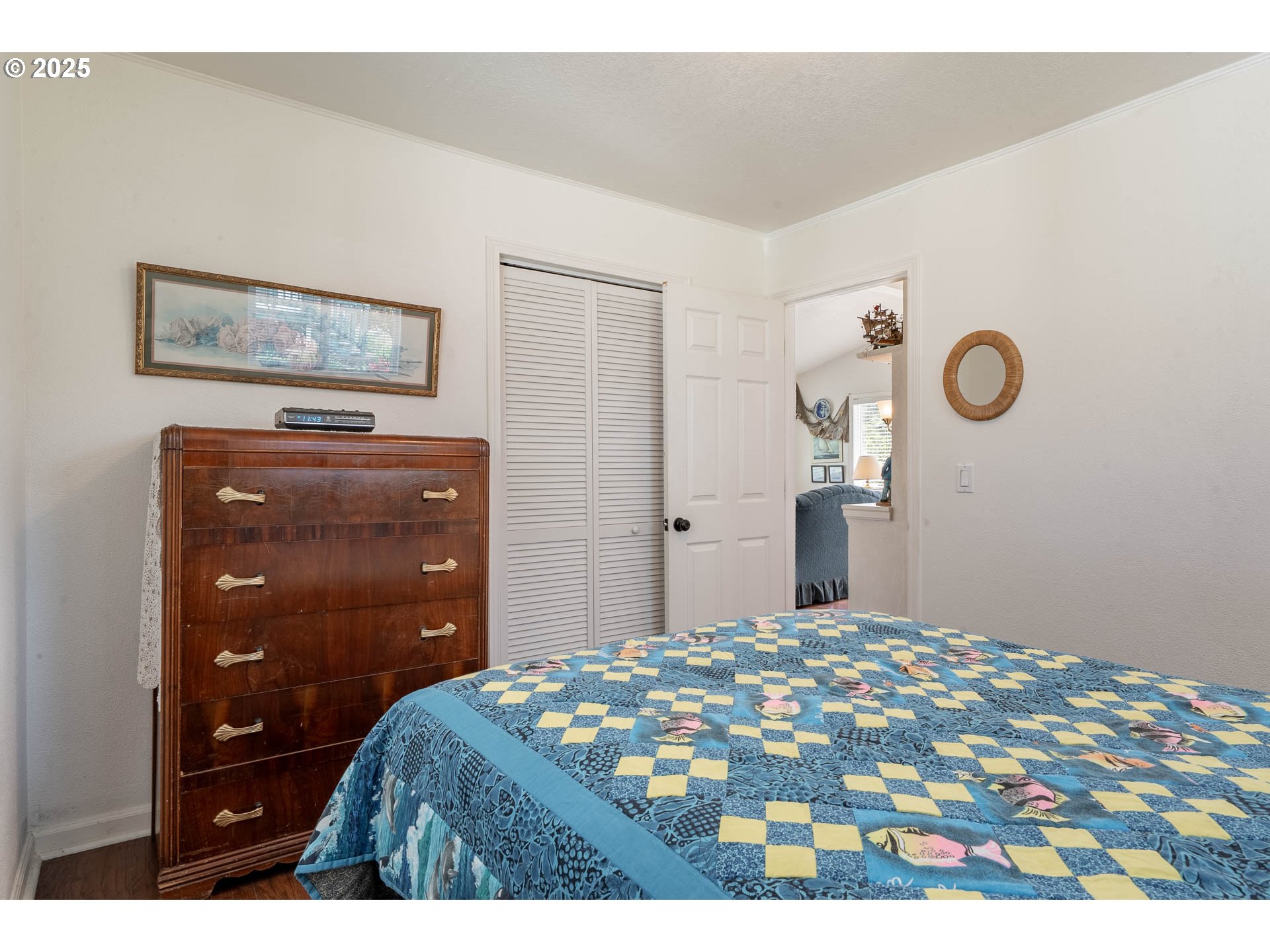 5305 Northeast 49th Street Neotsu, OR 97364 - Photo 27 of 32 a bedroom with a bed and a dresser