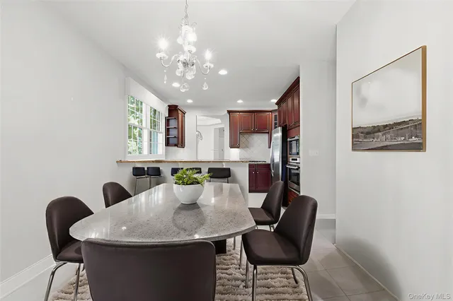 a view of a dining room with furniture and a chandelier fan