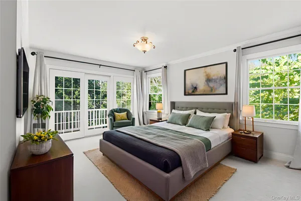 a bedroom with a bed and a large window