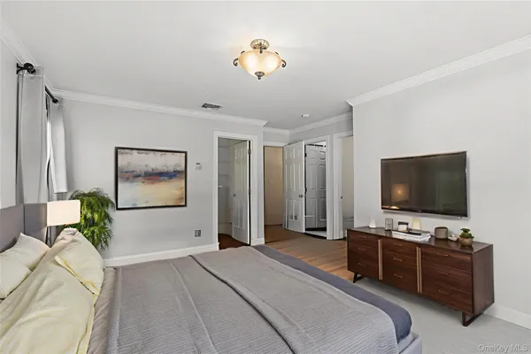 a bedroom with furniture and a flat screen tv
