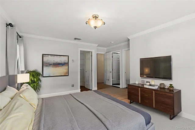 a bedroom with furniture and a flat screen tv