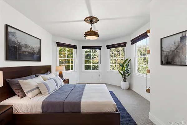 a bedroom with a large bed and a window
