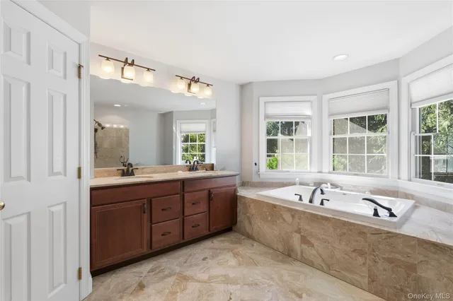 a spacious bathroom with sink bathtub and window