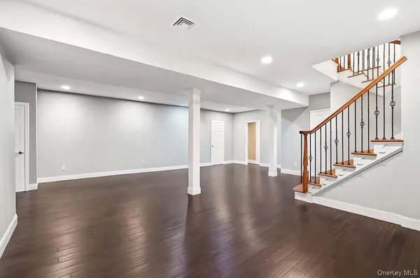 wooden floor in an empty room with stairs