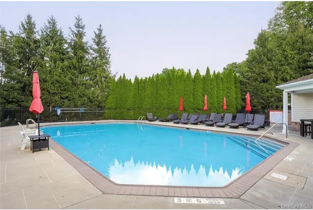 a living room with fireplace furniture and a large window