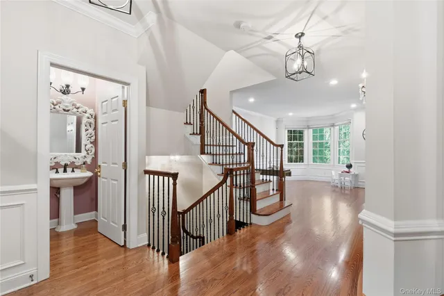 a view of entryway and hall with wooden floor
