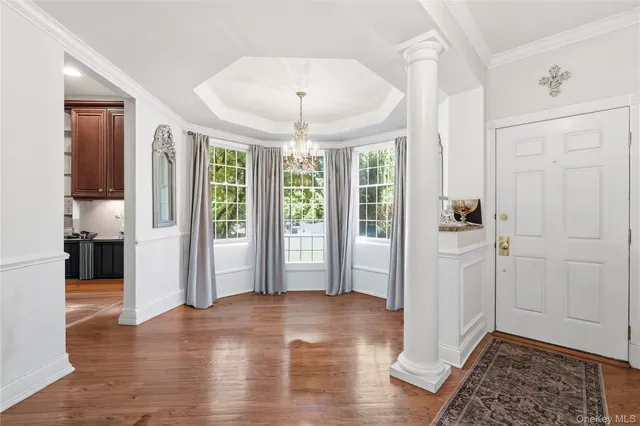 a view of a big room with wooden floor and windows