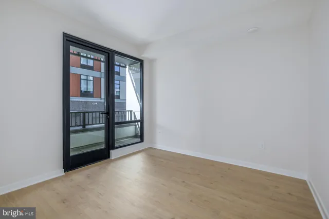 a view of an empty room with kitchen