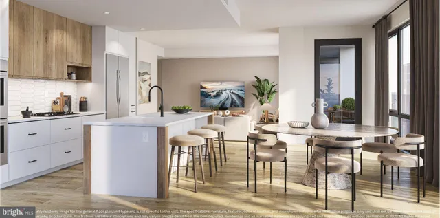 a kitchen with stainless steel appliances kitchen island granite countertop a table chairs and a refrigerator