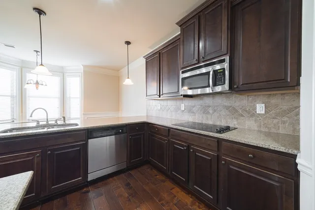 a kitchen with granite countertop stainless steel appliances and cabinets
