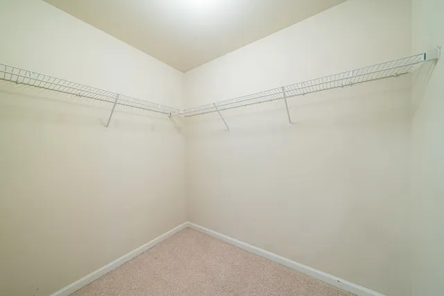 a spacious bathroom with a tub sink and mirror