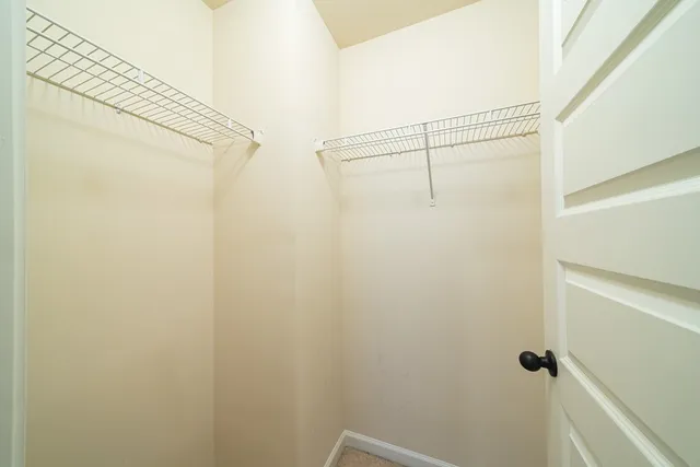 a bathroom with a double vanity sink toilet and a mirror
