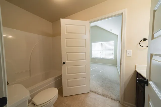 a bathroom with a shower a toilet and a sink