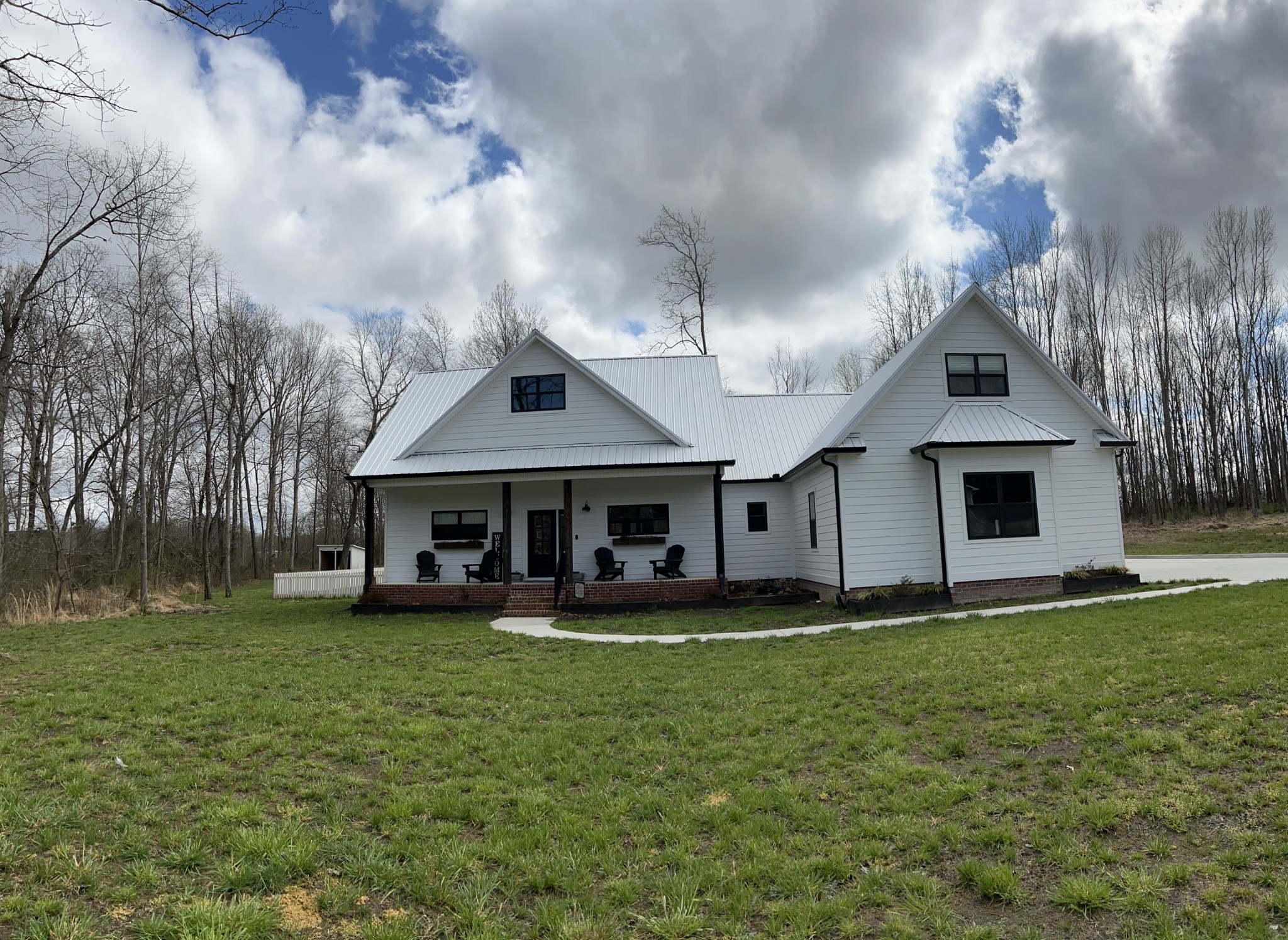 656 Taylor Road Manchester, TN 37355 - Photo 2 of 2 a view of a house with a big yard and large trees