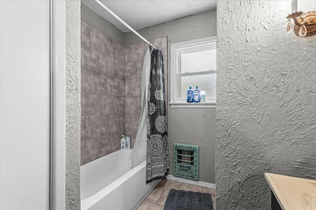 a bathroom with a bathtub and a shower