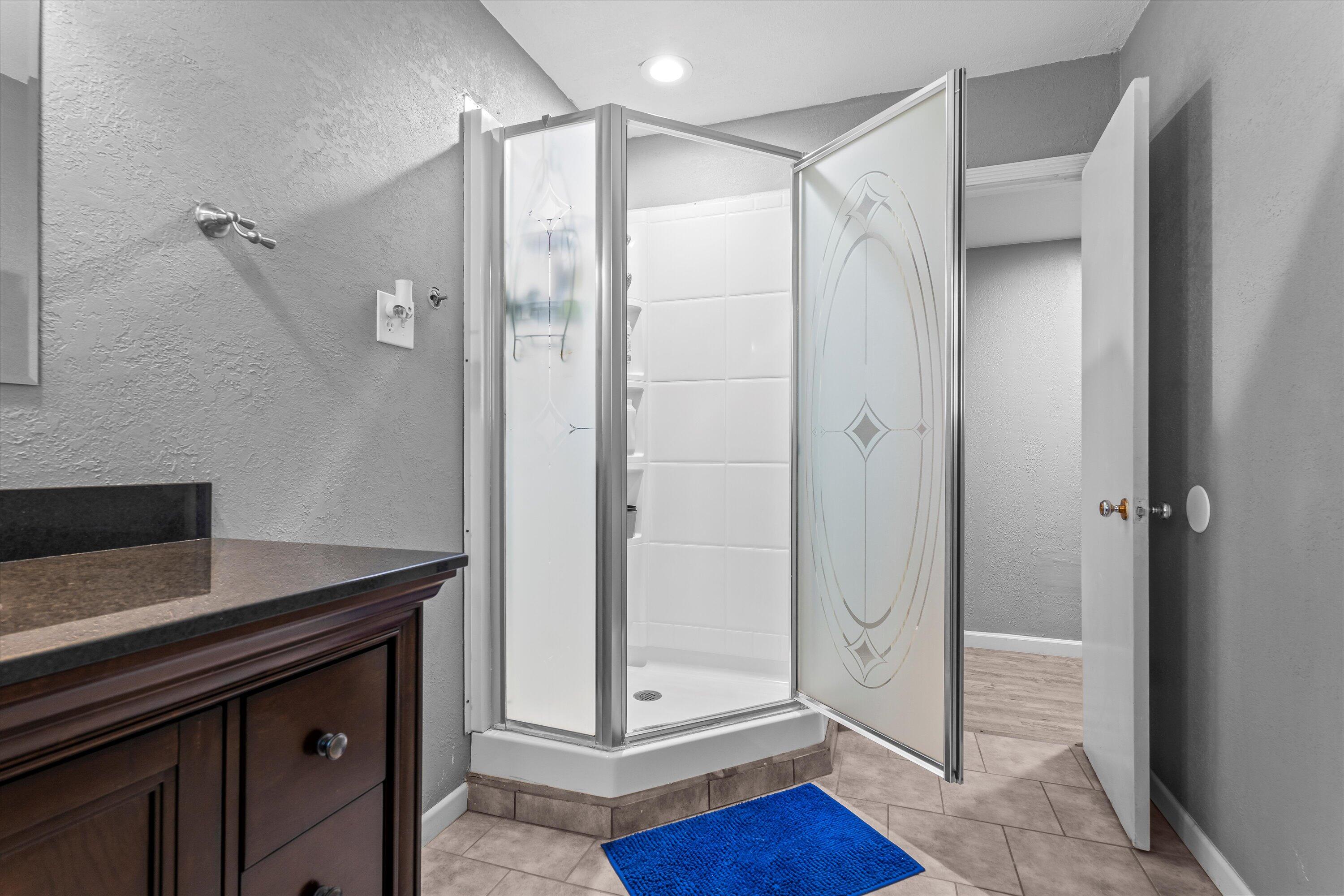 102 3rd Street Plains, TX 79355 - Photo 20 of 27 a bathroom with a shower and a sink