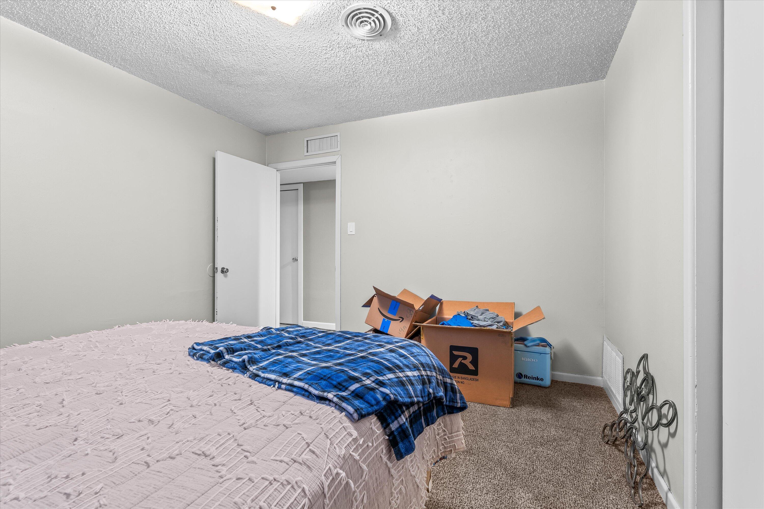 102 3rd Street Plains, TX 79355 - Photo 22 of 27 a bedroom with a bed and a table in it