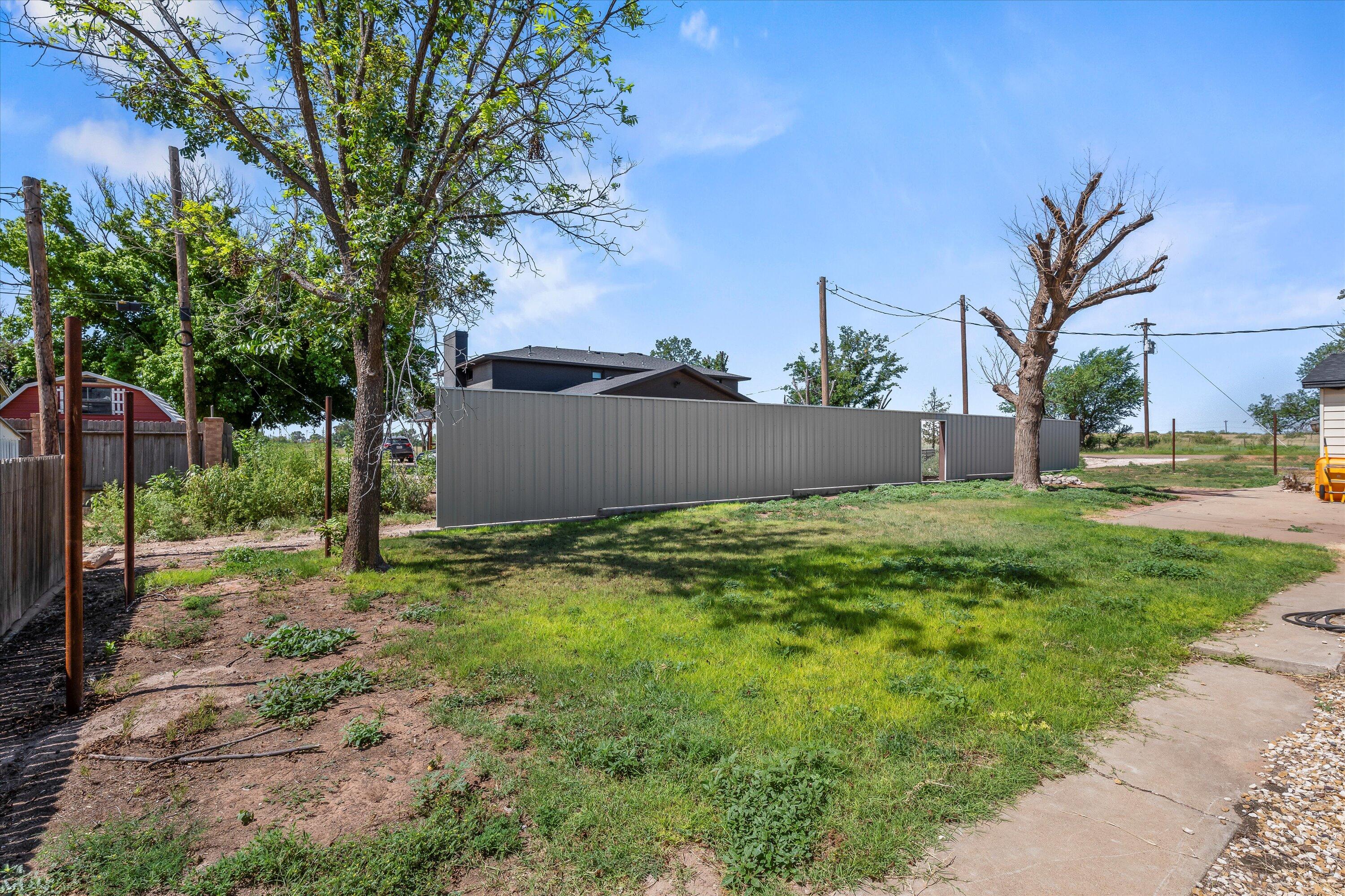 102 3rd Street Plains, TX 79355 - Photo 25 of 27 a backyard of a house with lots of green space