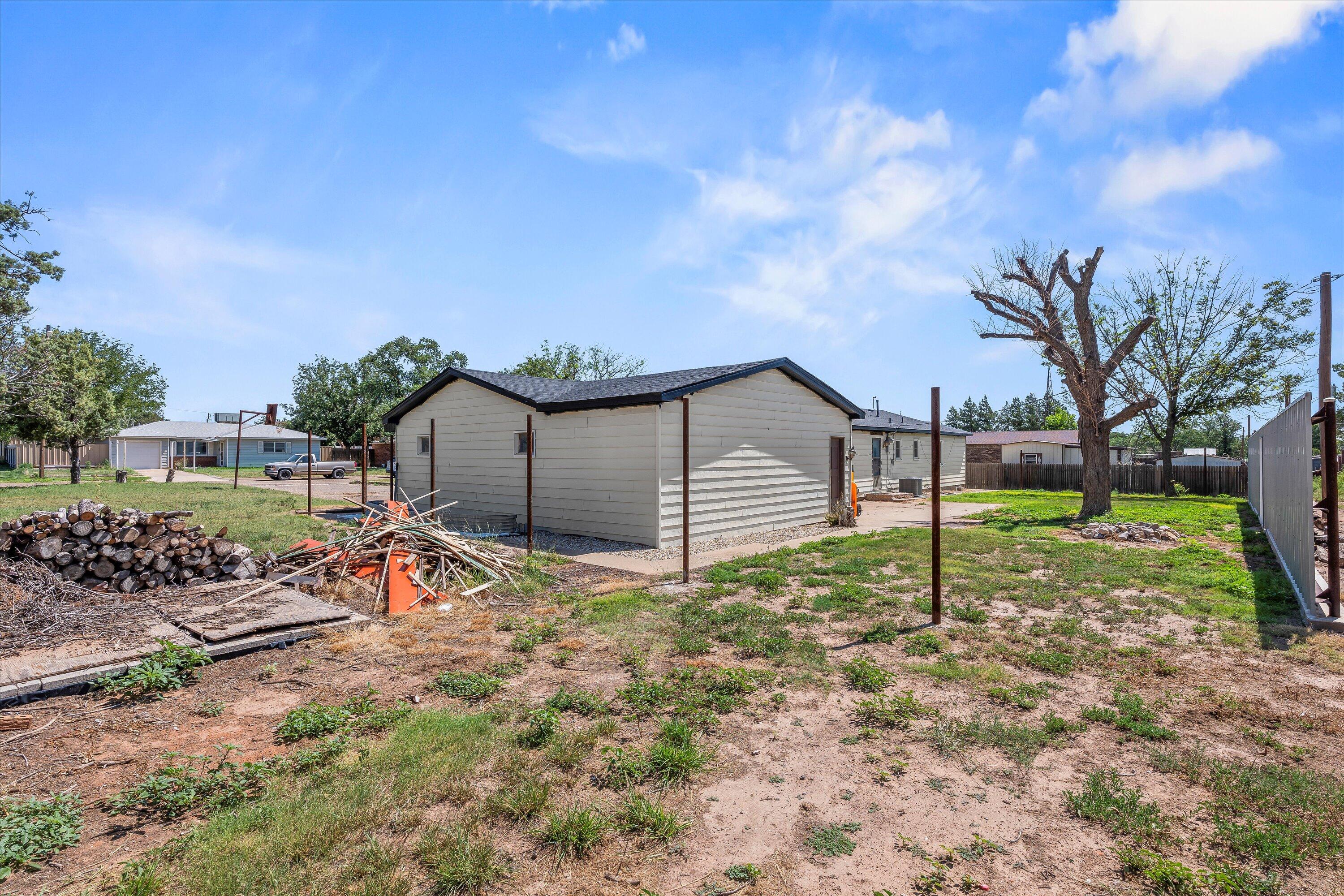 102 3rd Street Plains, TX 79355 - Photo 26 of 27 a view of a house with backyard and trees