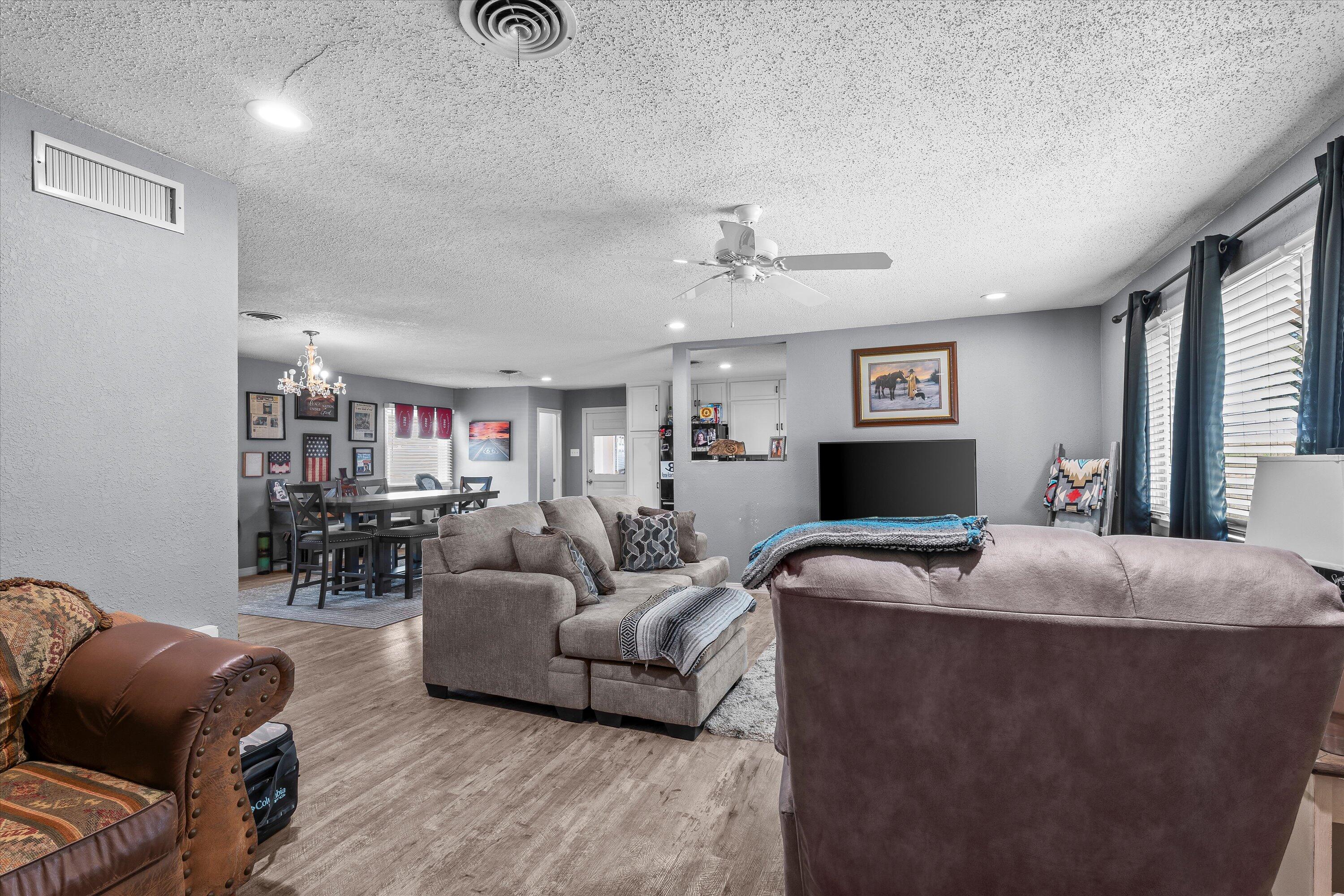 102 3rd Street Plains, TX 79355 - Photo 5 of 27 a living room with furniture and a flat screen tv