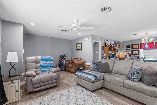 a living room with furniture and a chandelier