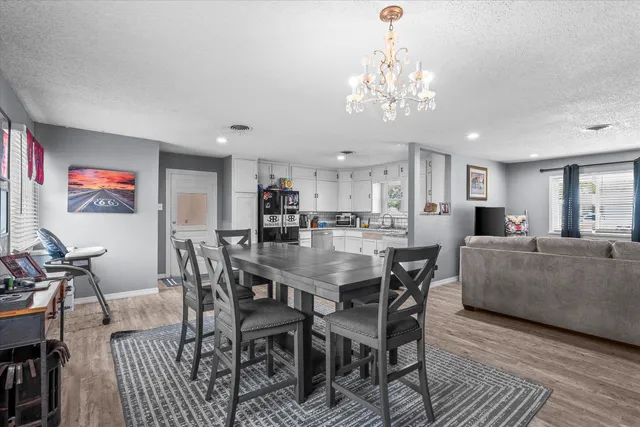 a view of a dining room with furniture and chandelier