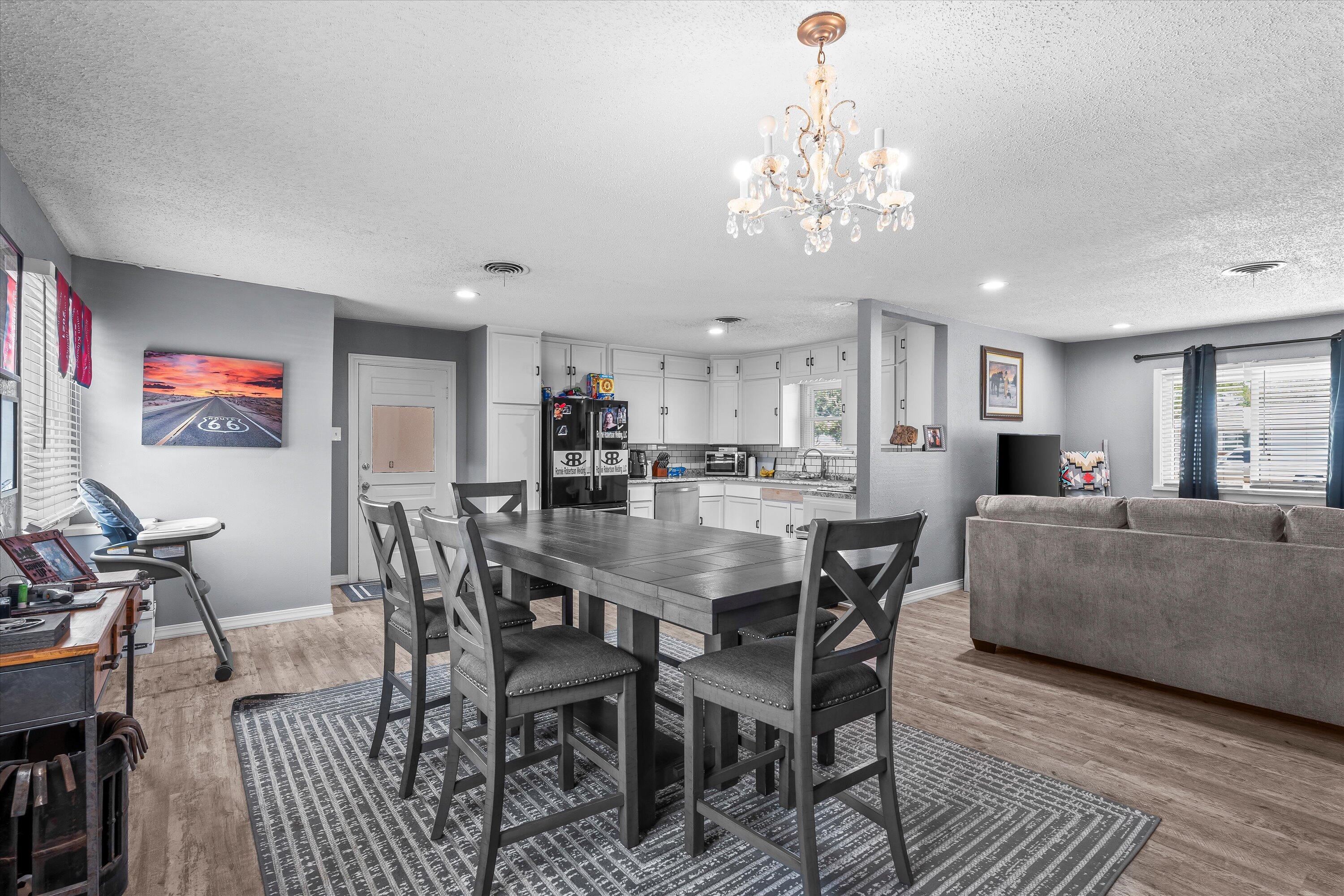 102 3rd Street Plains, TX 79355 - Photo 7 of 27 a view of a dining room with furniture and chandelier