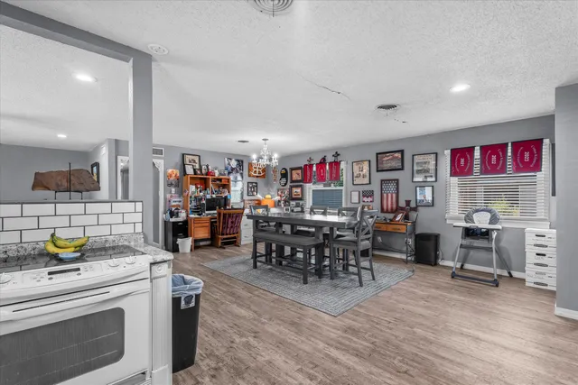 a living room with lots of furniture and kitchen view