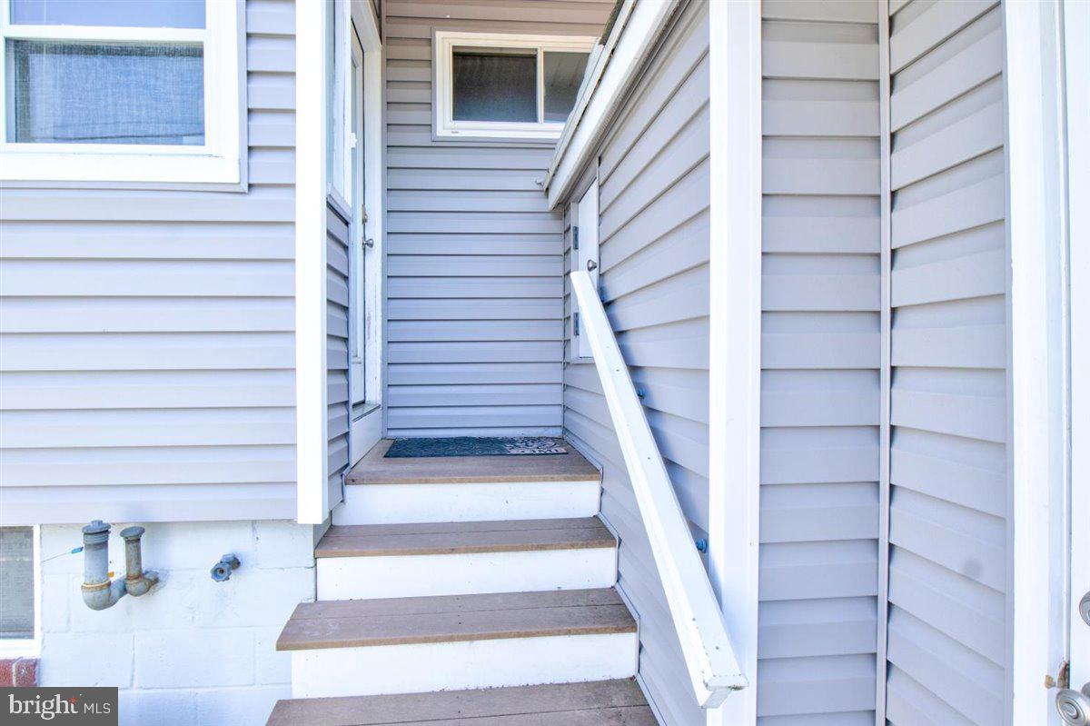 7517 B Street Chesapeake Beach, MD 20732 - Photo 24 of 78 a view of staircase with white walls and windows