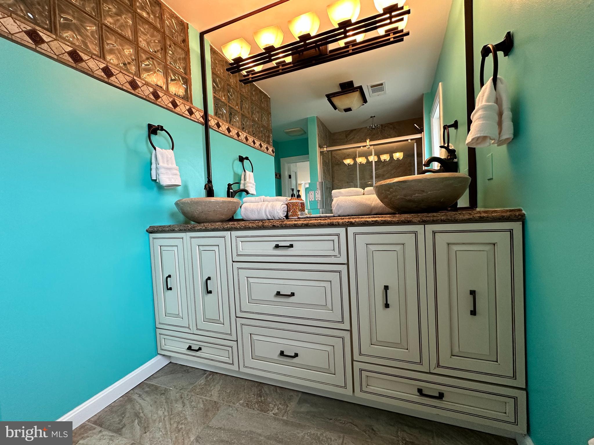 7517 B Street Chesapeake Beach, MD 20732 - Photo 61 of 78 a bathroom with a sink a vanity and mirror