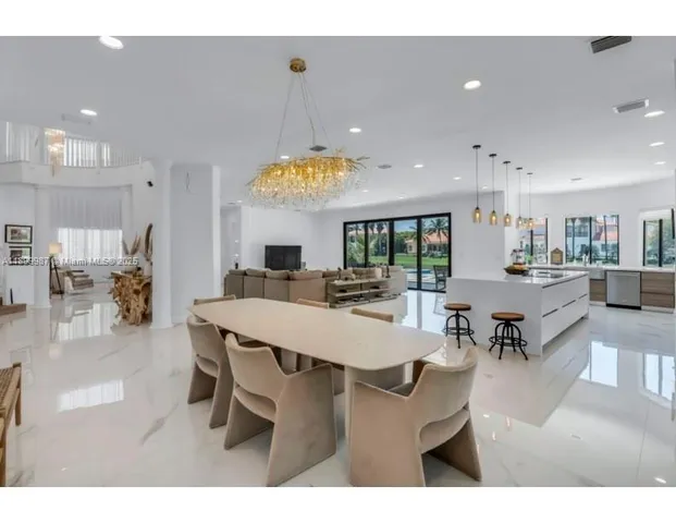 a living room with lots of furniture and a chandelier