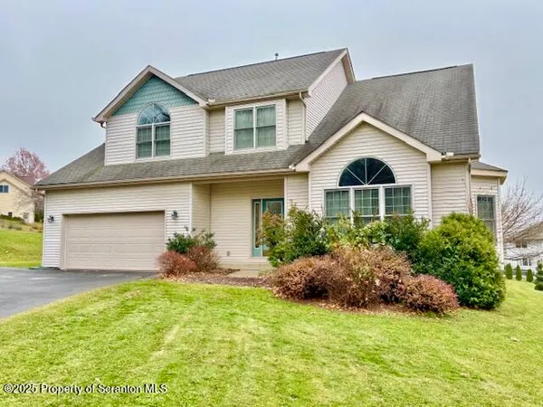 a front view of house with yard and green space