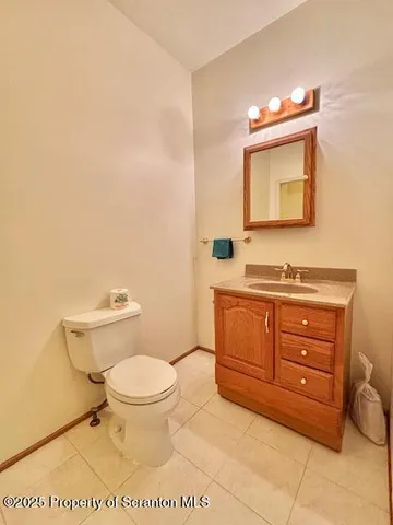 a bathroom with a toilet a sink and a mirror