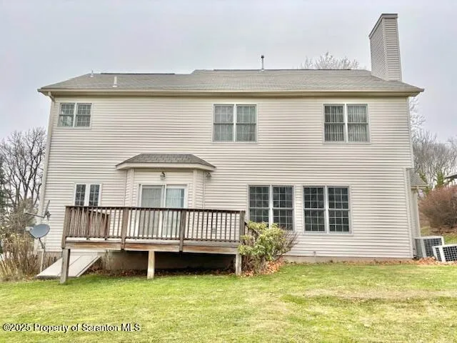 a view of a house with a yard and deck