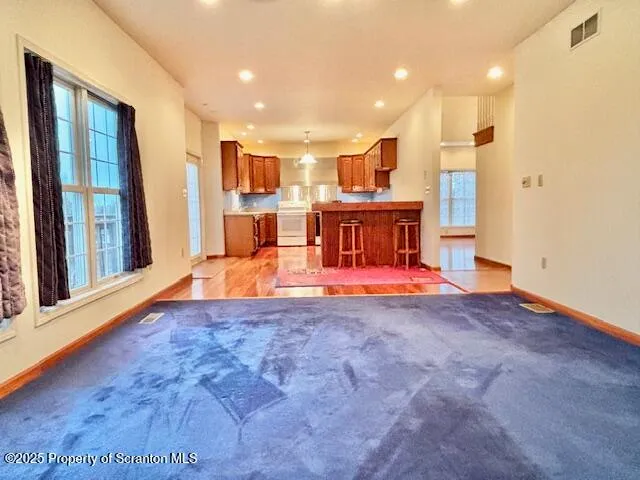 a view of a kitchen with a refrigerator and a window