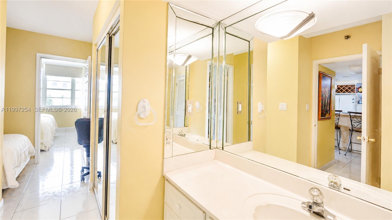 100 Lincoln Road, Unit 422 Miami Beach, FL 33139 - Photo 10 of 23 a en suite bathroom with a sink a mirror and a shower