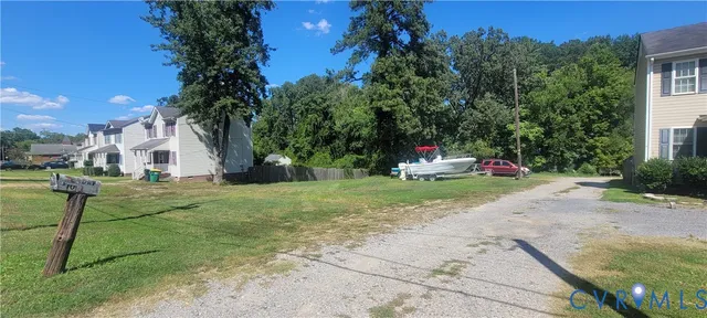 a white house with trees in front of it