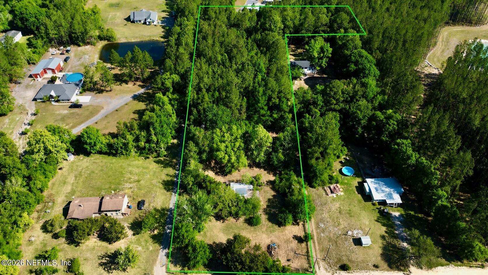 36507 Pratt Siding Road Callahan, FL 32011 - Photo 1 of 14 an aerial view of residential house with swimming pool and lawn chairs