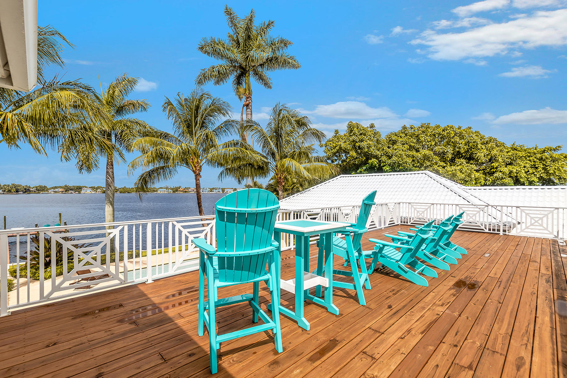 75 River Drive Tequesta, FL 33469 - Photo 31 of 42 a view of a chairs and table on the wooden deck
