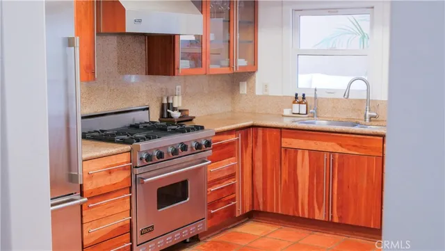 a kitchen with stainless steel appliances granite countertop a stove and a sink
