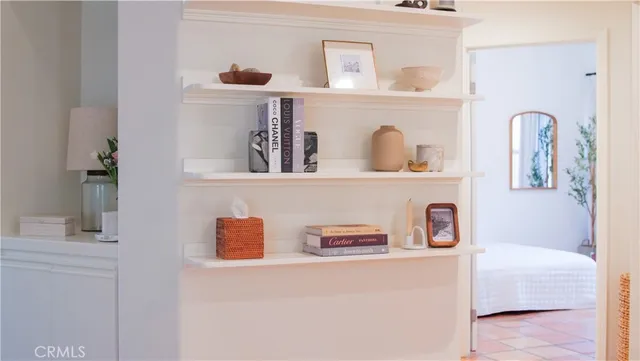 a bedroom with a bed and a potted plant