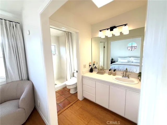 a bedroom with a bed and a potted plant