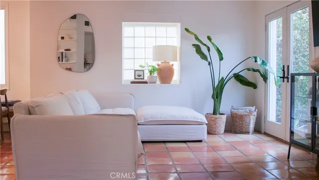 a living room with furniture rug and wooden floor