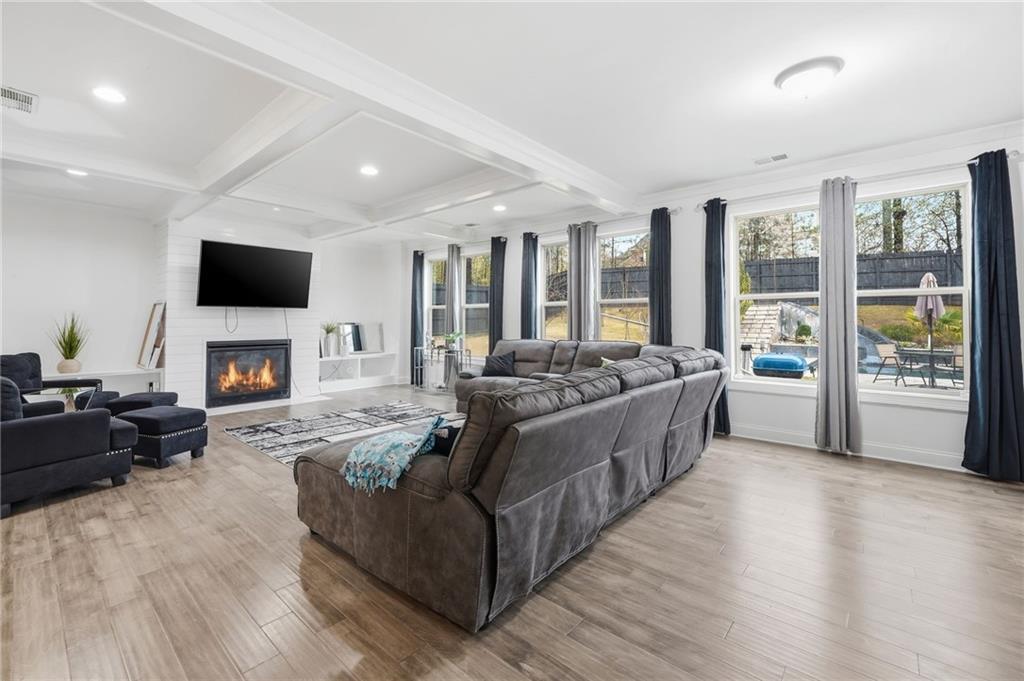 5115 Five Forks Trickum Road Southwest Lilburn, GA 30047 - Photo 11 of 63 a living room with furniture fireplace and flat screen tv