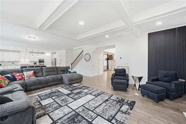 a large kitchen with kitchen island a island a stove a table and chairs in it