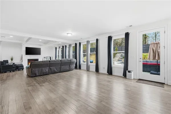 a kitchen with stainless steel appliances kitchen island granite countertop a table chairs sink refrigerator and cabinets